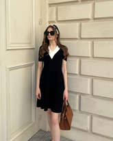 a lady wears a  black v-neck knitted midi dress